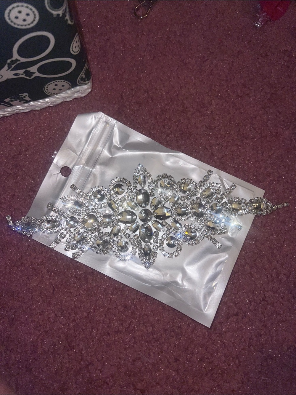 Silver embellishment for sewing.